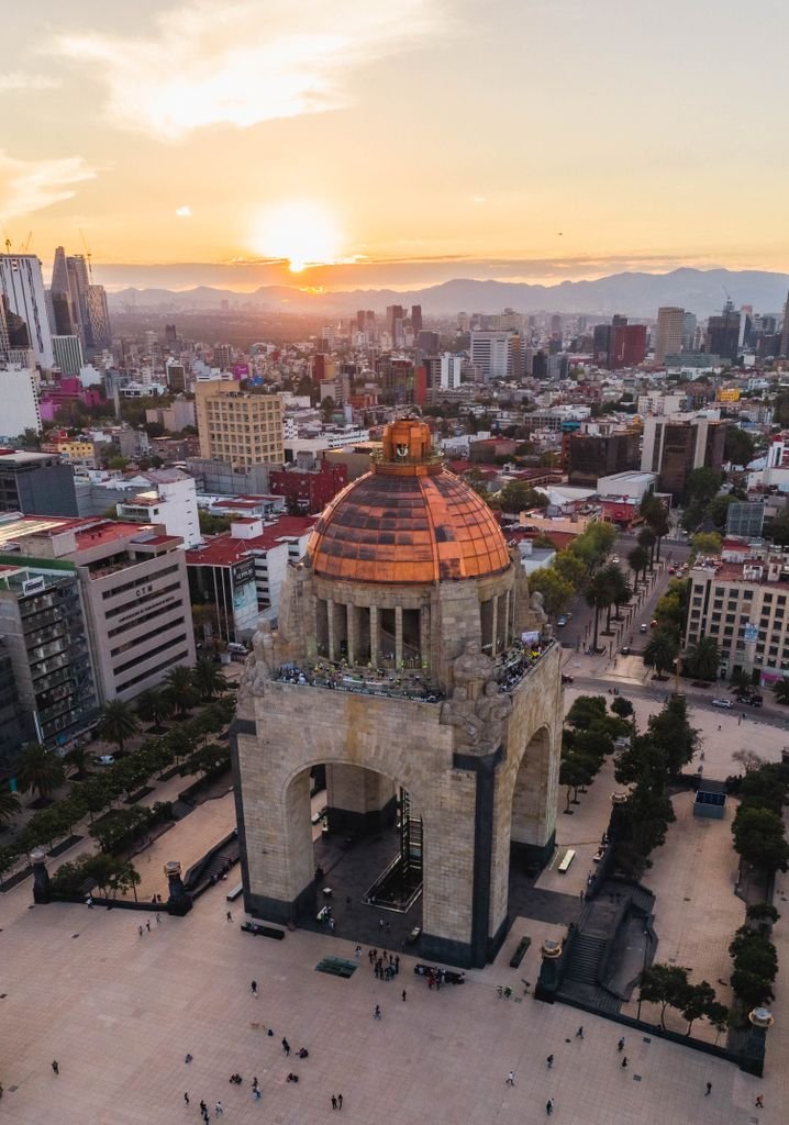A breathtaking aerial view of Monumento a la Revolución in Mexico City during sunset.