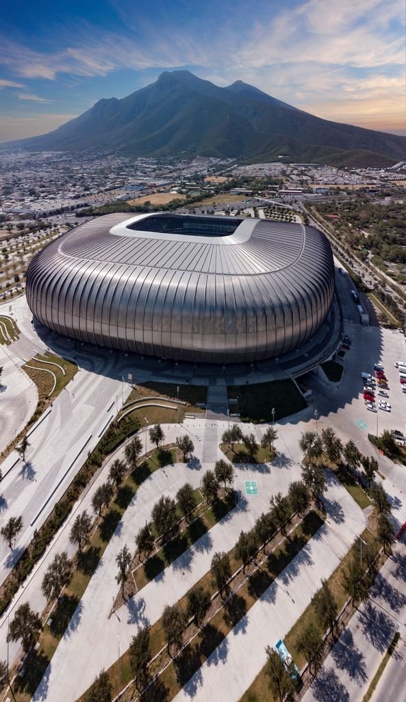A stunning aerial shot of Estadio BBVA with mountainous backdrop in Guadalupe, Mexico.