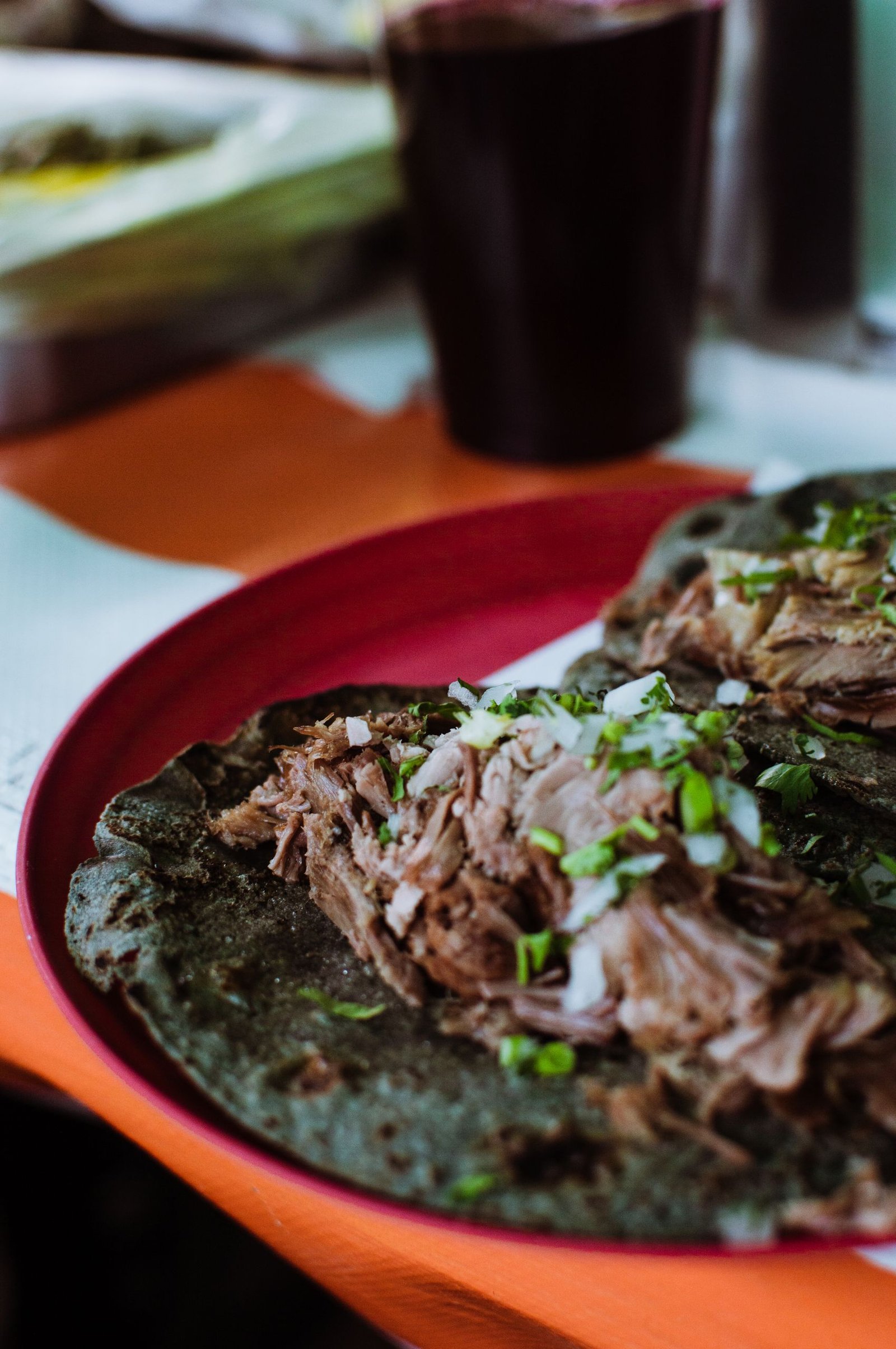 Close-up of authentic Mexican tacos with fresh cilantro and onion, perfect for food enthusiasts.