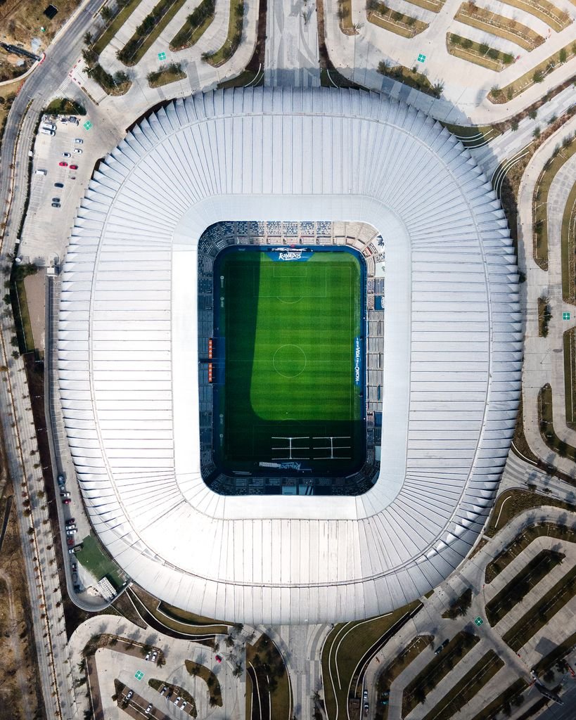 Drone shot of Estadio BBVA in Guadalupe, showcasing the stadium's unique architecture from above.