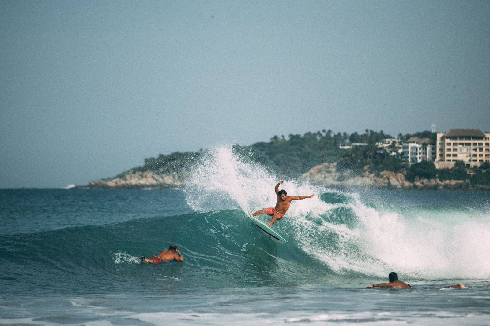 Exciting surfing scene capturing a surfer riding waves on a beach in Mexico.