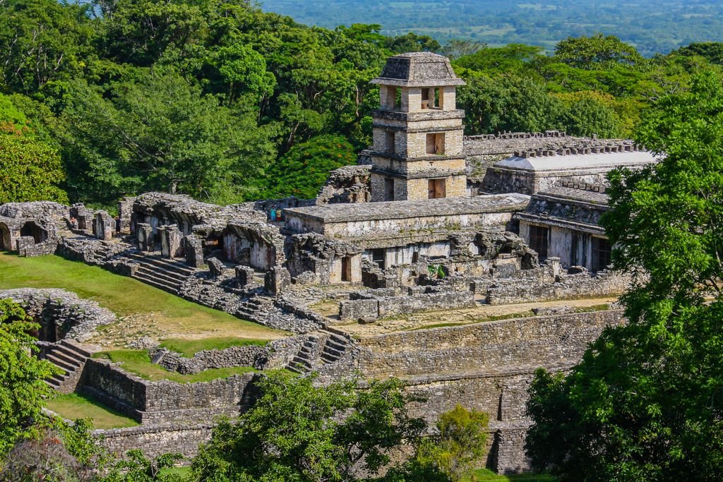 Explore the ancient stone ruins of Palenque nestled in the vibrant lush jungles of Mexico, a historic tourist attraction.