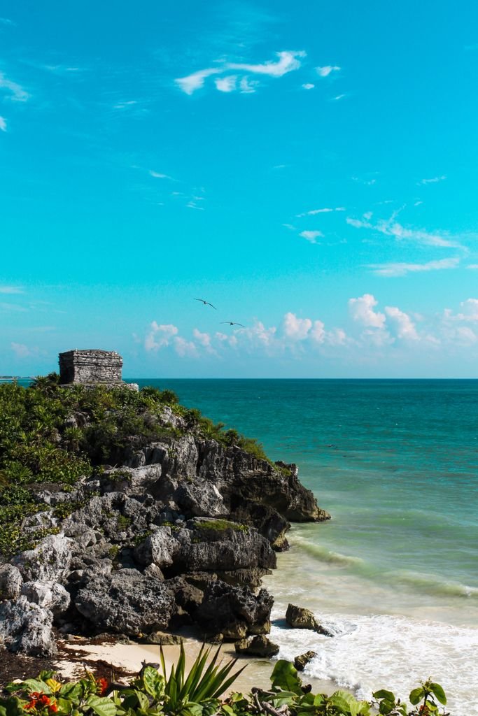 Explore Tulum's ancient Mayan ruins perched on cliffs above the Caribbean Sea.