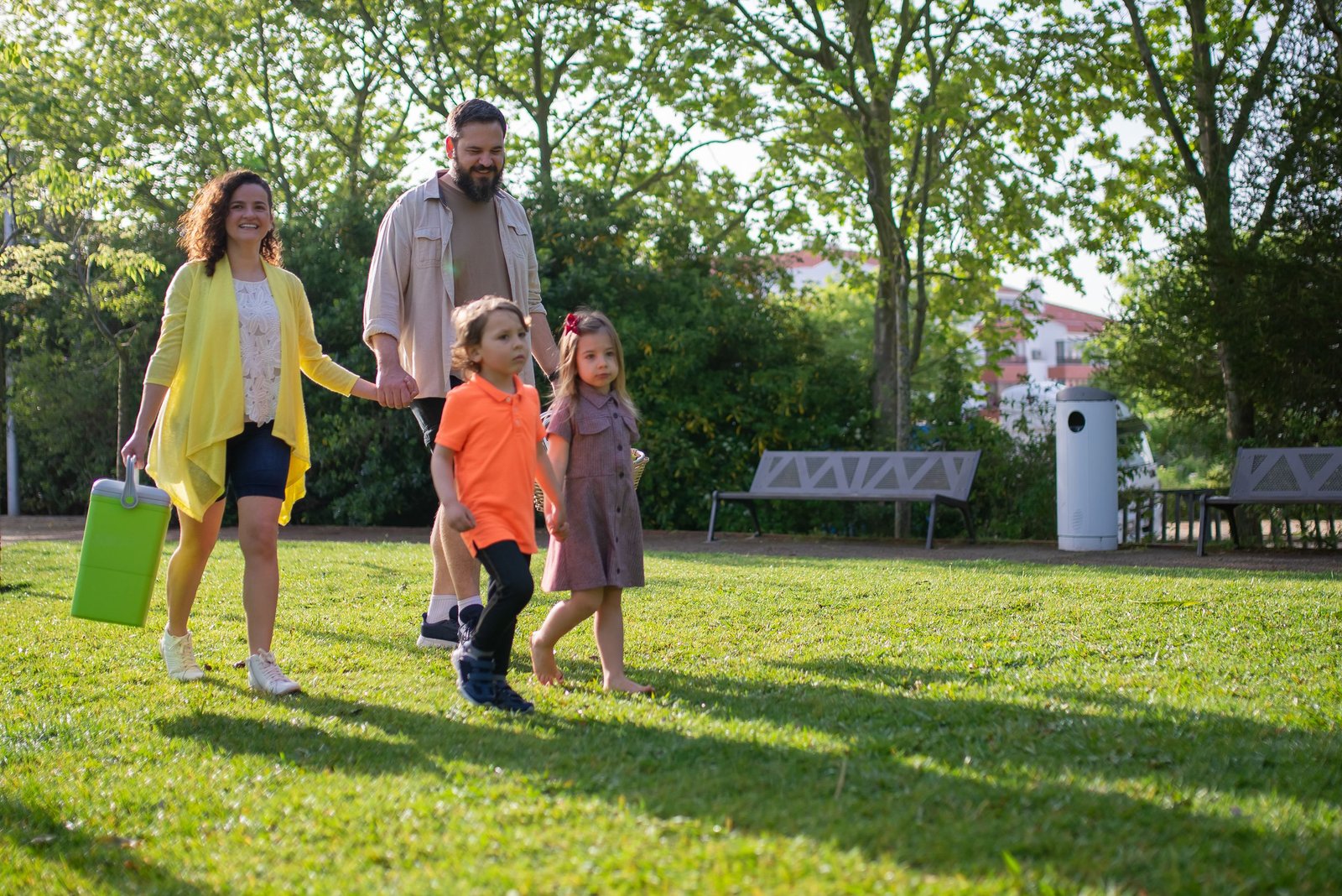 A joyful family with children strolling in a sunny Portuguese park.