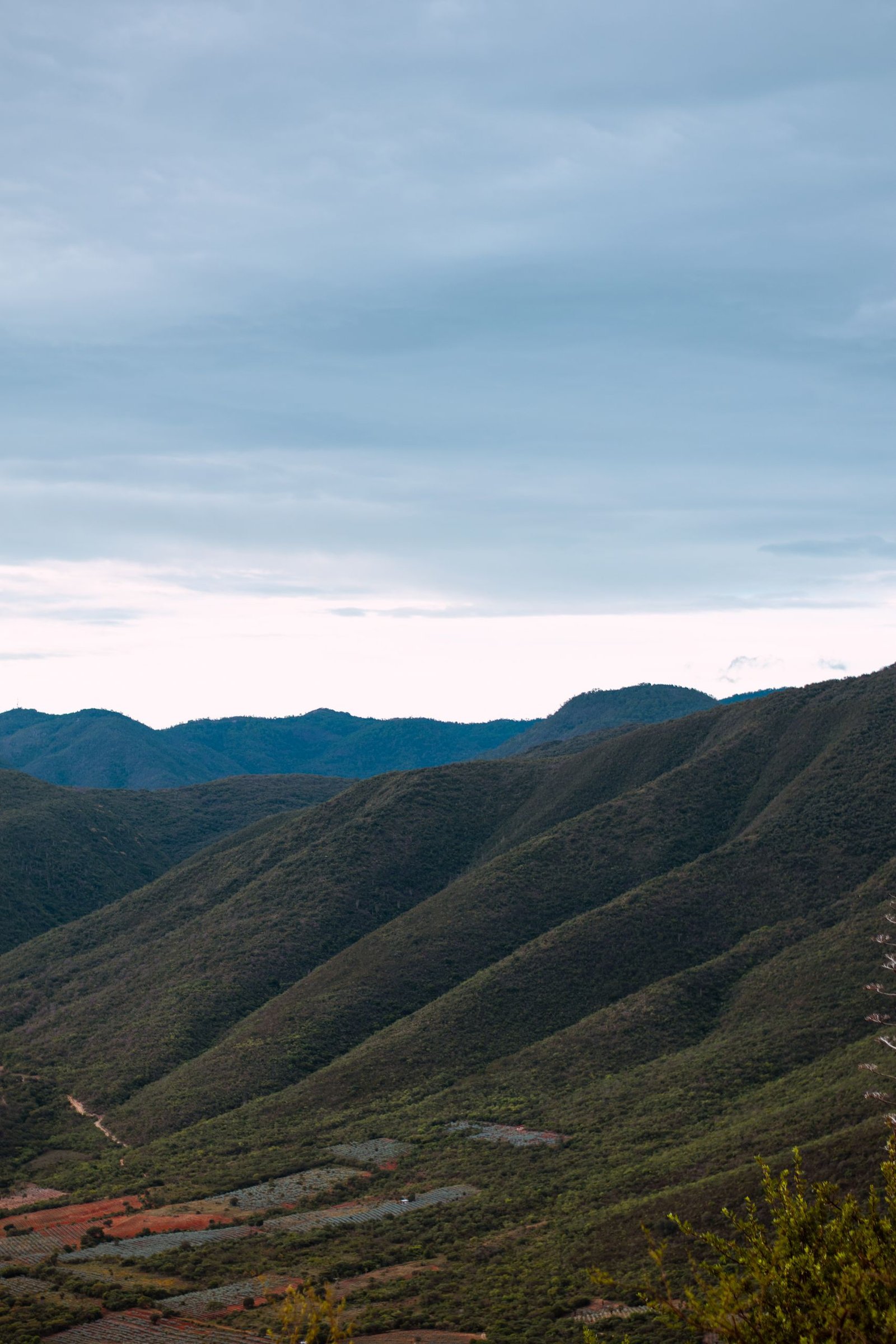 Beautiful landscape of rolling mountains under a cloudy sky in Oaxaca, Mexico.