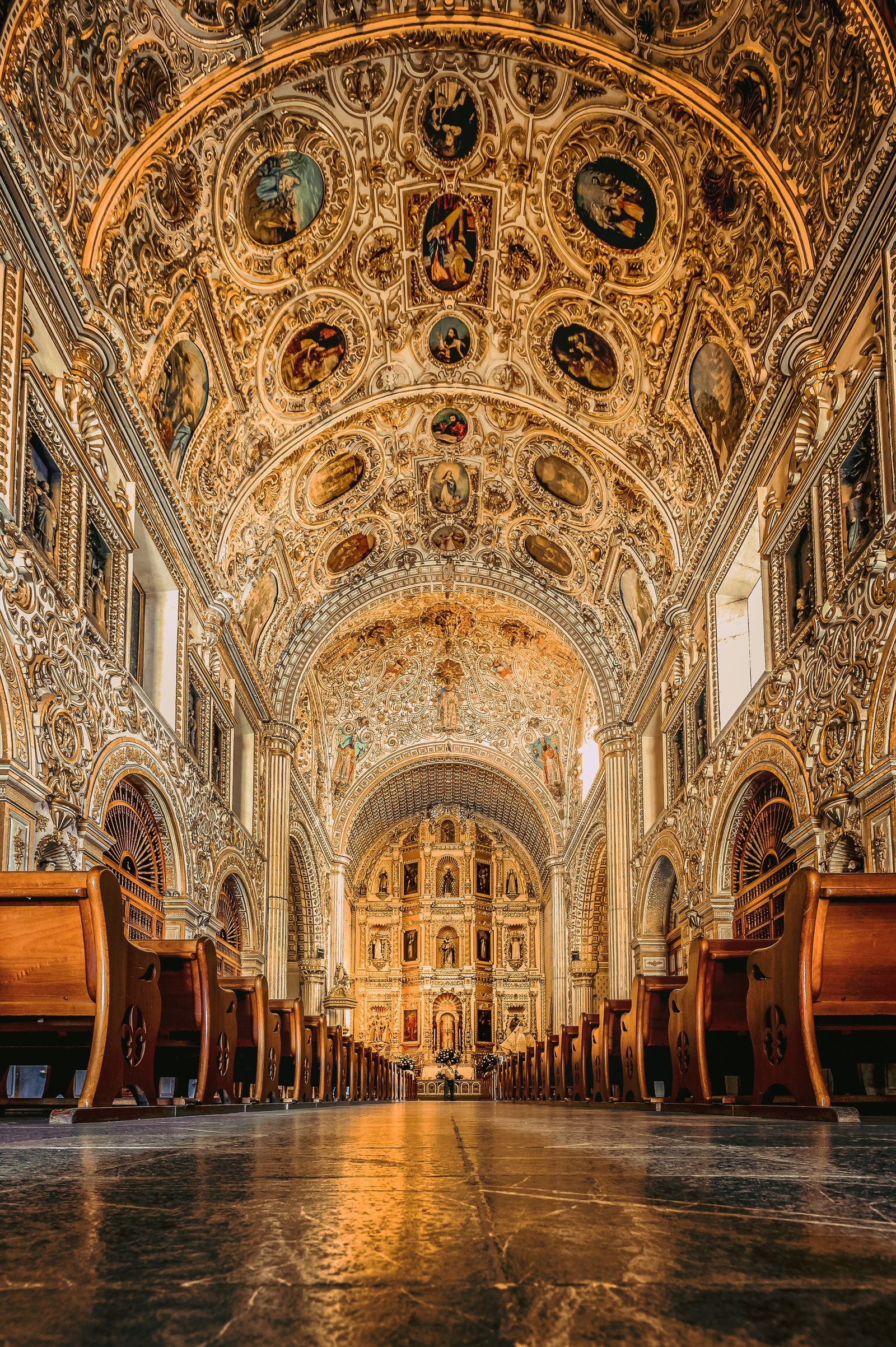 Experience the ornate, gold-adorned interior of the Santo Domingo church in Oaxaca, Mexico's architectural treasure.