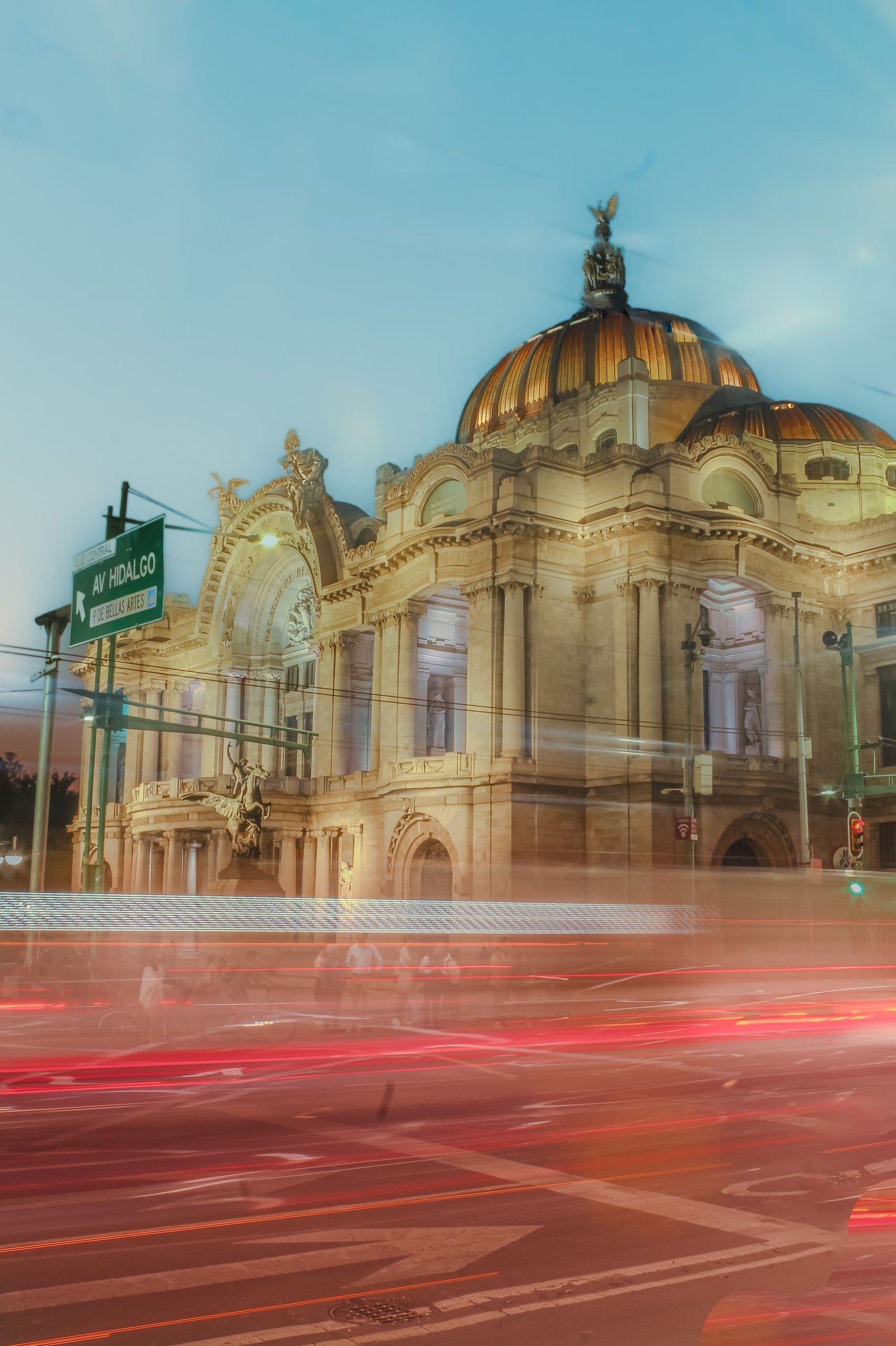 Stunning view of Palacio de Bellas Artes with light trails in Mexico City at twilight.