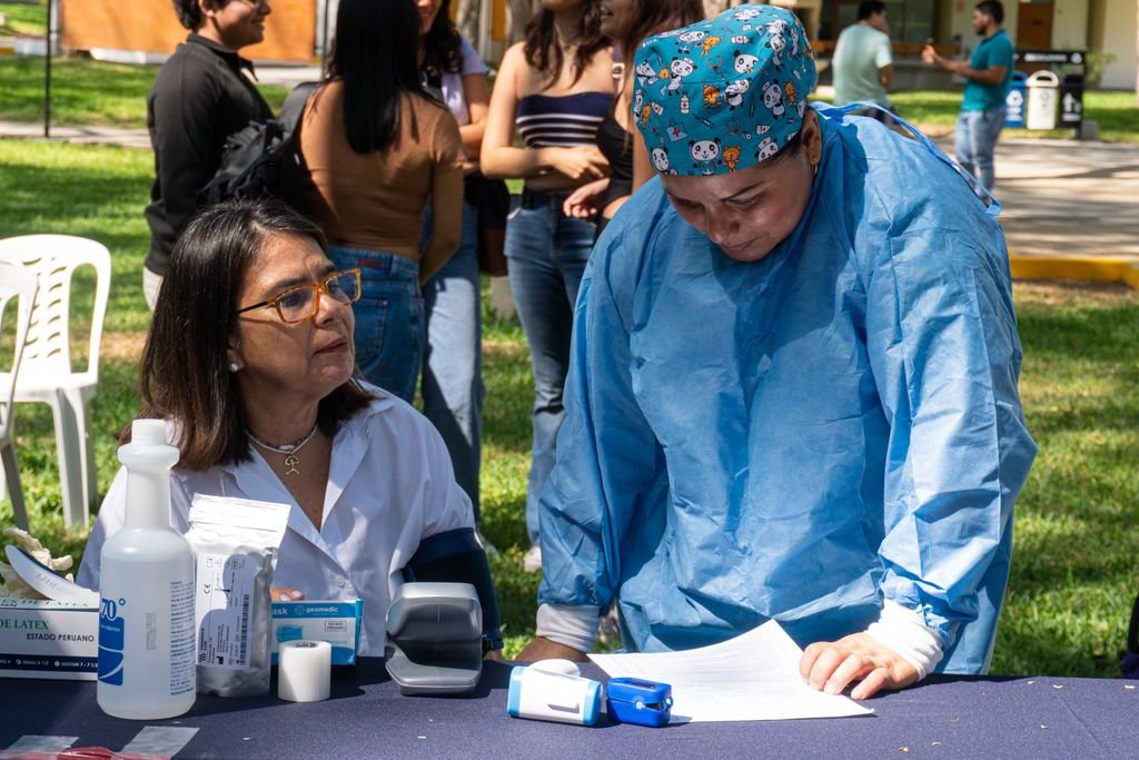A health professional assists at a community health awareness event in Piura, Peru.