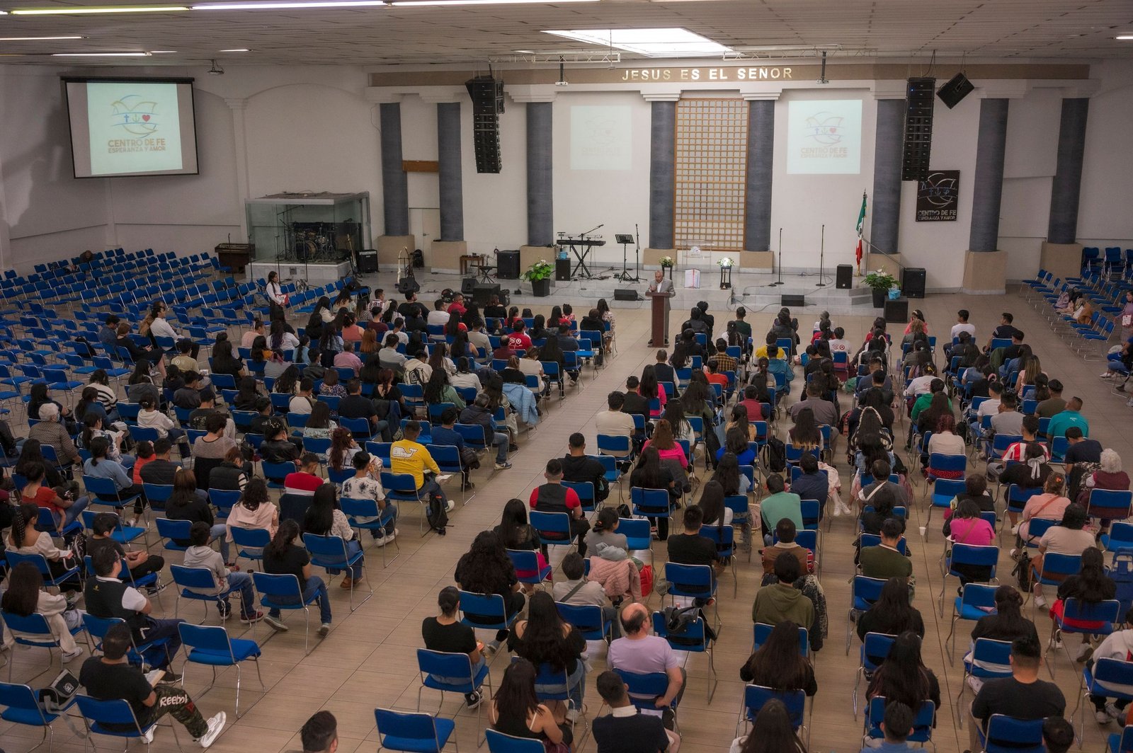 A large audience seated in a church auditorium attending a seminar.